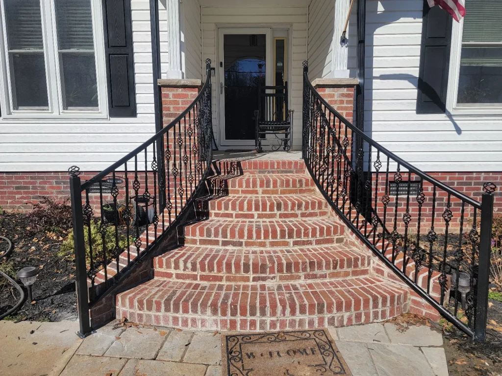 Custom wrought iron stair railings on brick steps
